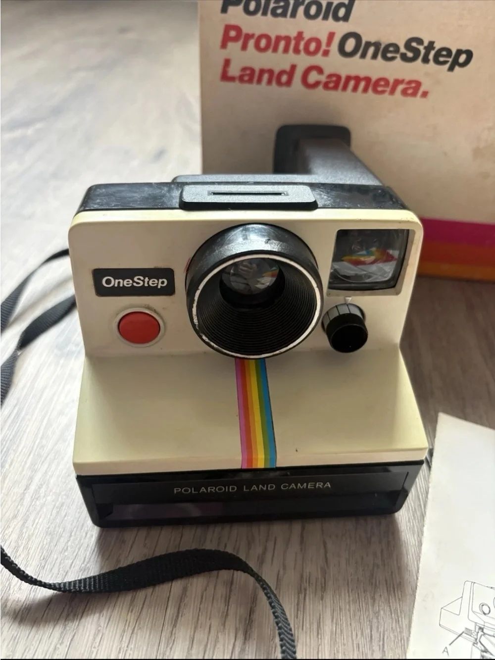 Polaroid OneStep Land Camera — cream body with rainbow stripe